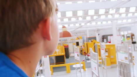 Young-white-boy-using-air-pressure-rocket-at-science-centre