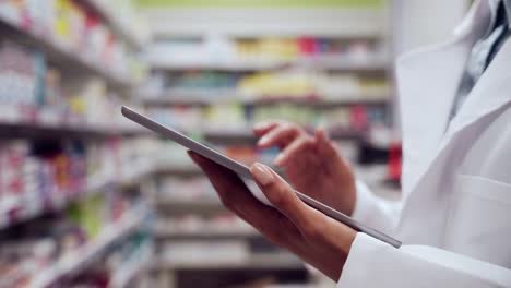 close up female pharmacist typing on digital tablet