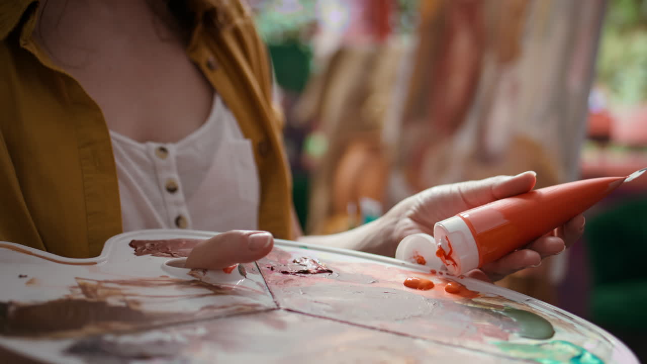 Artist preparing paint on palette