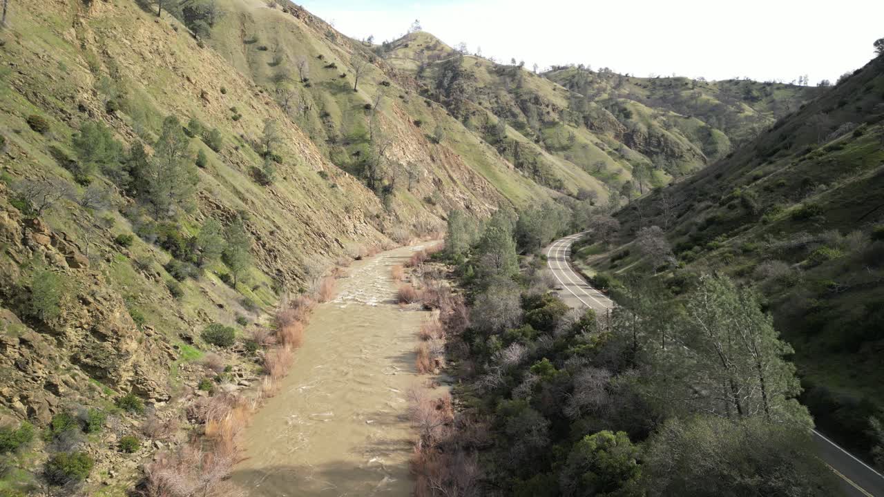 Aerial drone footage captures Cache Creek winding through Rumsey, California, with its rugged natural beauty.
