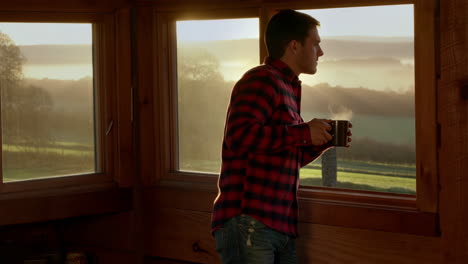 man enjoying morning coffee with scenic view