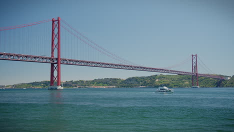 25 april bridge in belem lisbon boats passing by