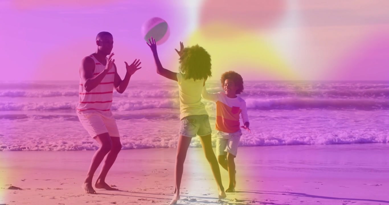Girl tossing beach ball, dad catching, boy jumping near waves, light-leak overlay for family play