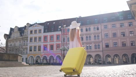 horizontal video in real time of a happy smiling blond woman with summer clothes walking along a tropical beach