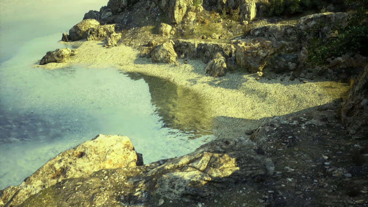 Serene coastal landscape with clear water and rocky shore at sunset