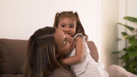 happy young woman and daughter embracing at home