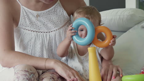 baby playing with toy ring pyramid