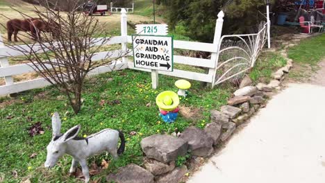 sign to grandma and grandpa's house with horse's in the background