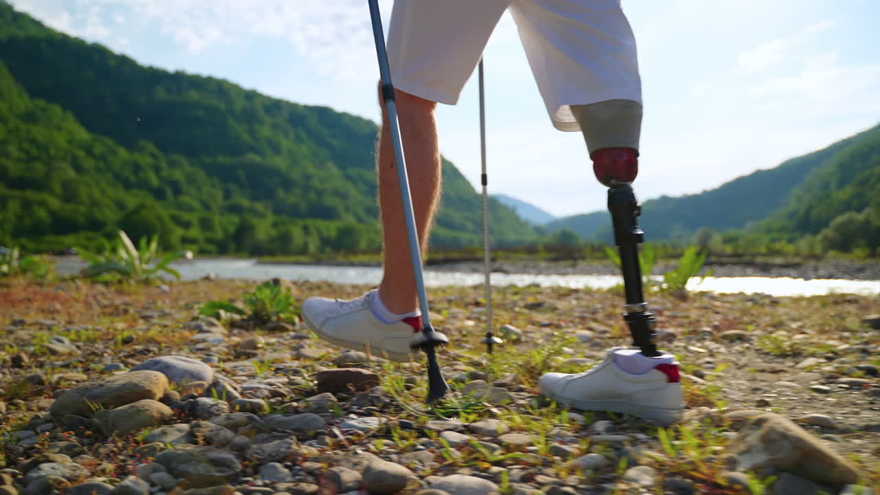 persona con una pierna protésica haciendo senderismo en las montañas