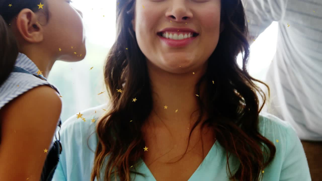 Mom getting cheek-kisses child leaning in showing love dad leaning closer star filter for social