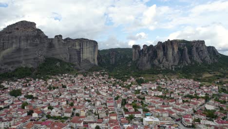 meteora kalabaka greece aerial dolly shot, city center and mountain rocks panoramic view at dawn