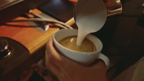 barista preparing cappuccino with lake