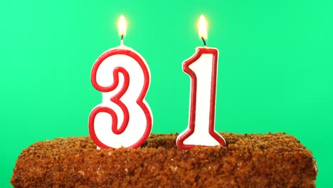 cake with the number 31 lighted candle. chroma key. green screen. isolated