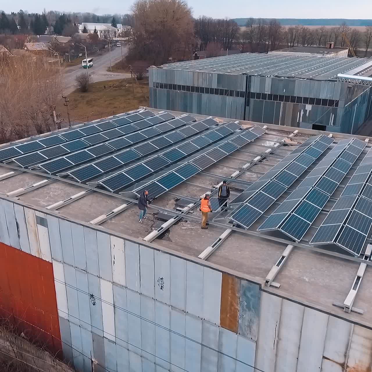 Solar panels installation. View from above on a solar energy farm on the roof of a big building. Renewable source of energy. Aerial view.