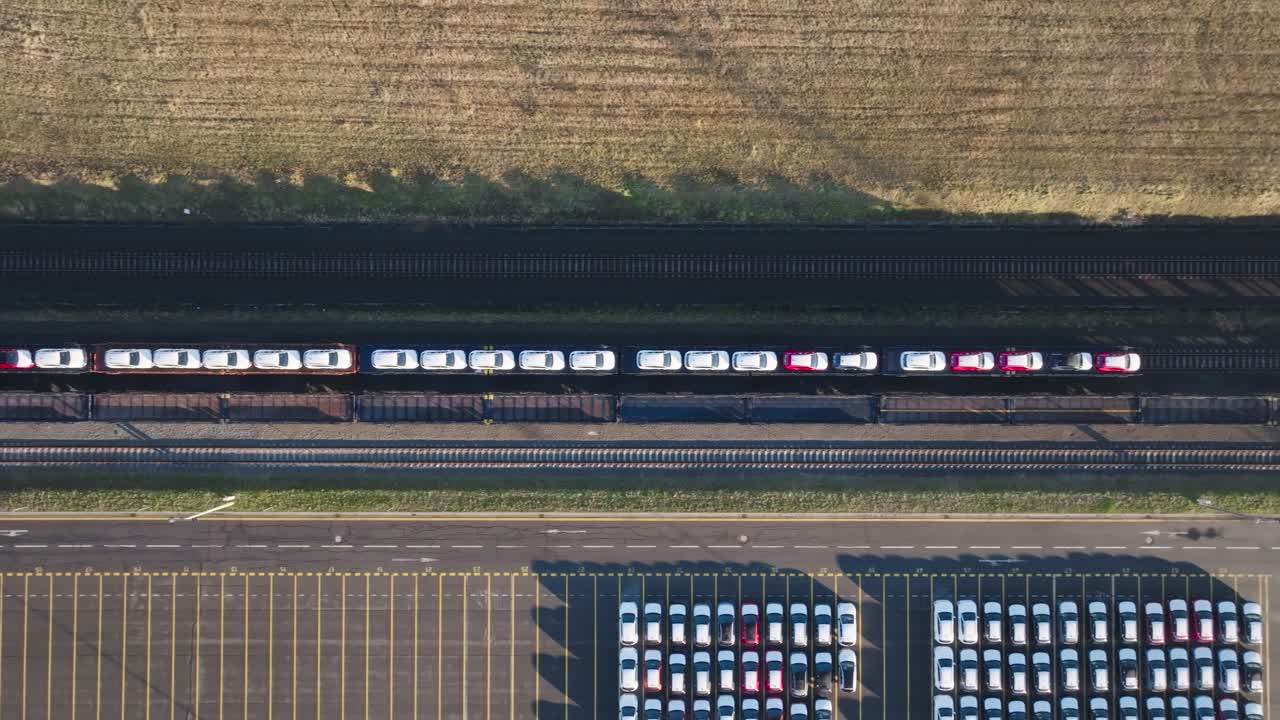 Aerial top down - cars on train carriage platform ready for transportation