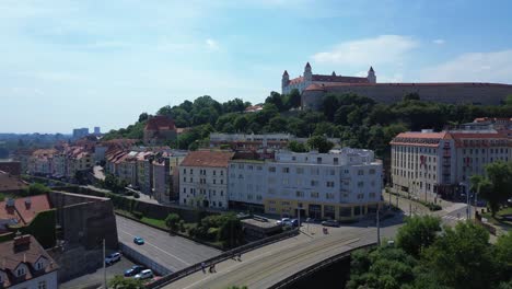 aerial view of bratislava castle and old town during the day, drone aerial view 4k establishing shot of the slovakian european capital city during the summer, stunning view of the landmark