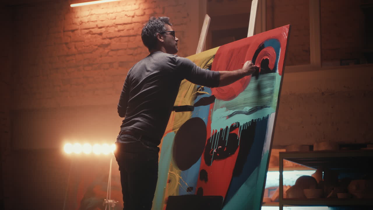 Artist painting abstract art in a studio