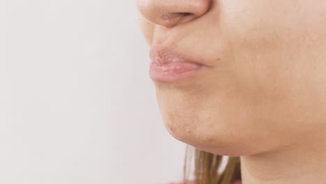 close-up portrait of woman eating pear. eat fruit.