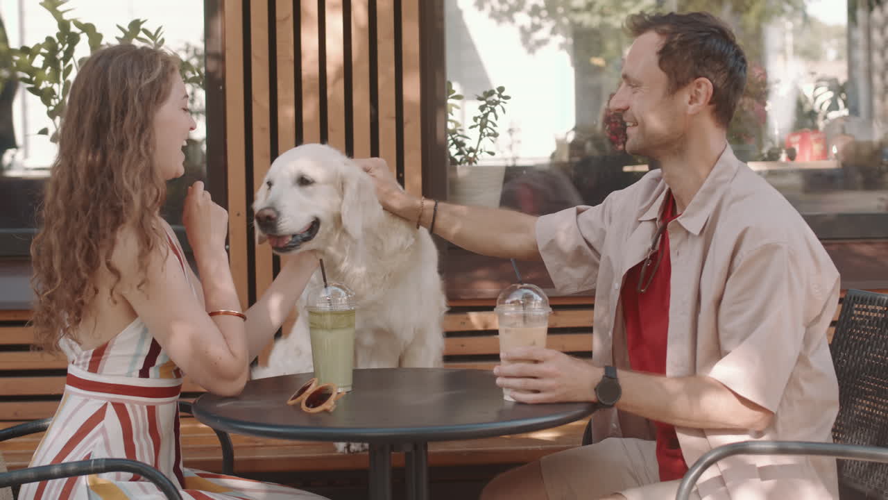 Couple Petting Dog in Cafe