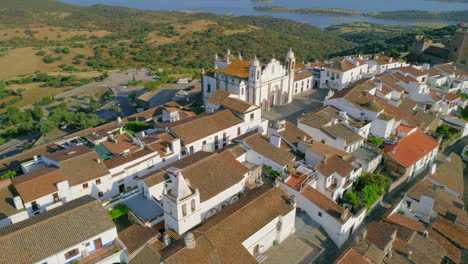 orbiting shot over picturesque monsaraz village with alqueva lake in the distance, alentejo