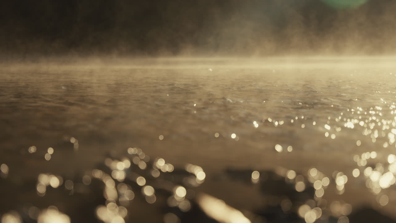 Steam rising from a shallow riverbed