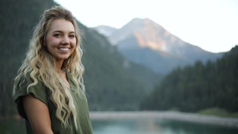 slow motion shot of a happy beautiful blonde female overlooking a gorgeous scene in the mountains-2