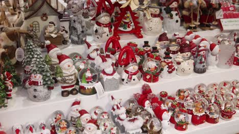 shopping for christmas globes at a festive christmas market in strasbourg, france europe