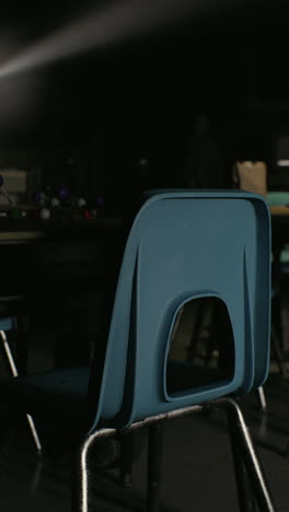 a blue chair in an empty classroom