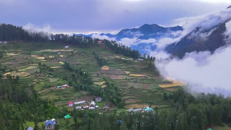 drone shot of a cloudy sainj valley in himachal pradesh near manali, kasol