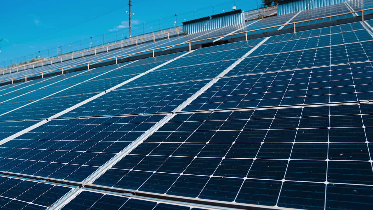 Photovoltaic panels at sunlight. Modern solar farm with blue sunny batteries. Renewable source of clean energy. Innovative electricity station.