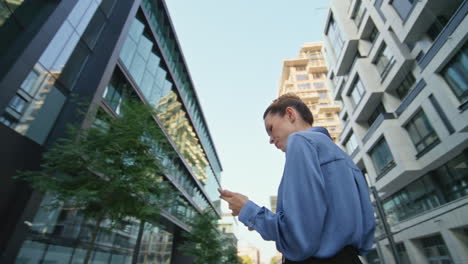 angry woman shouting smartphone at urban street. furious businesswoman hung up