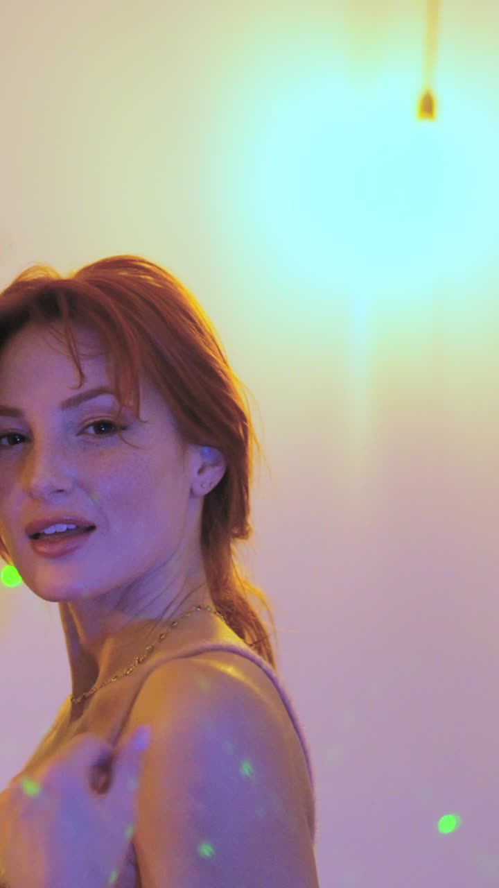 Women flirting blowing a kiss while dancing in a party