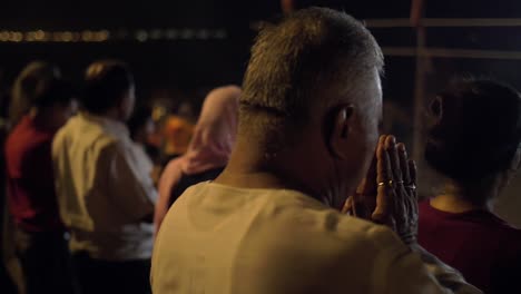 a man praying at religious ceremony in varanasi