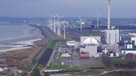 epz nuclear power plant facility with spinning wind turbines in background