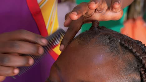 Professional-hairdresser-styling-you-woman’s-hair-with-comb-and-fingers