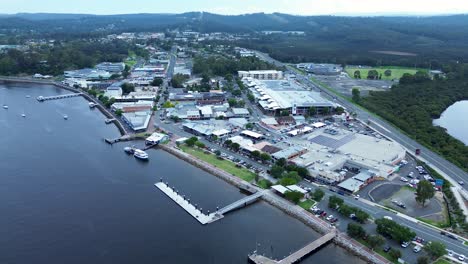 drone aerial shot of batemans bay rural town main centre suburb commercial shops street on river architecture south coast tourism australia