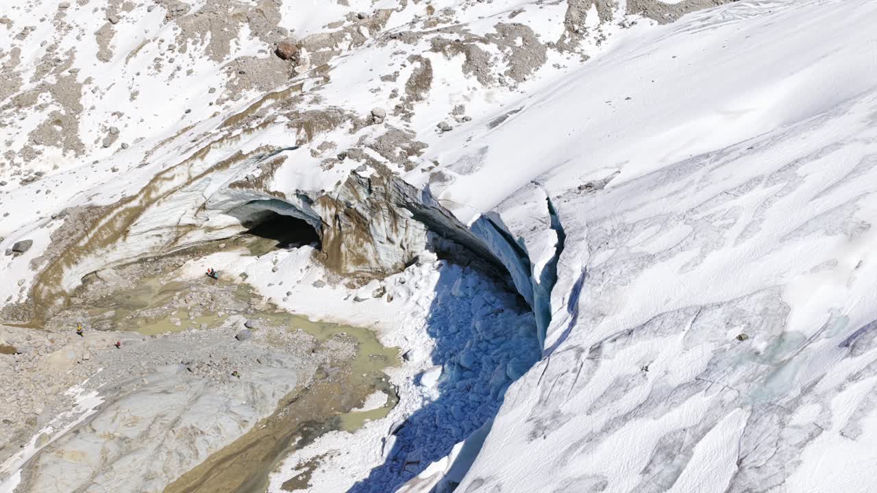 Icy Cave Mouth At Morteratsch Glacier In Bernina Range, Switzerland. aerial shot