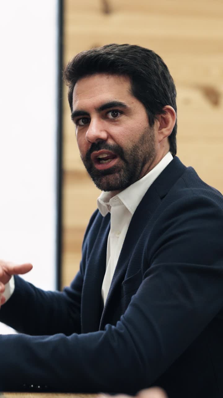 Man Talking and Gesturing During a Business Meeting