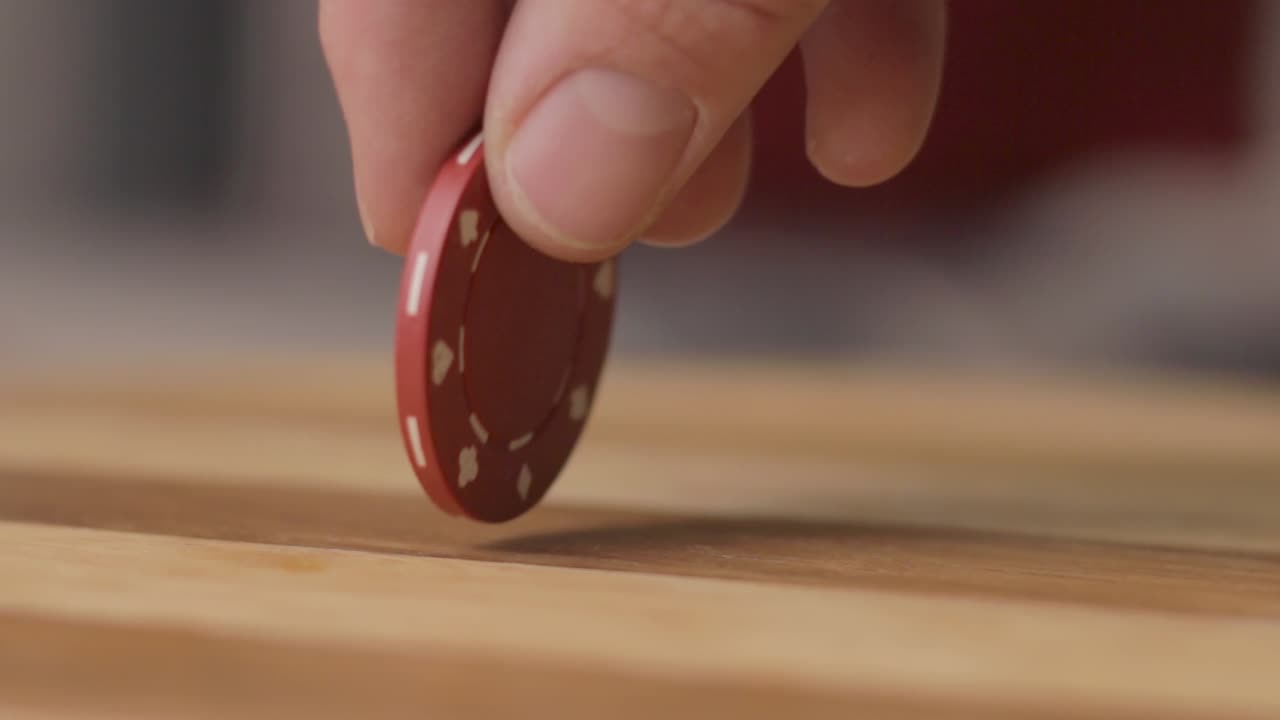 static close up of a man spinning a poker chip