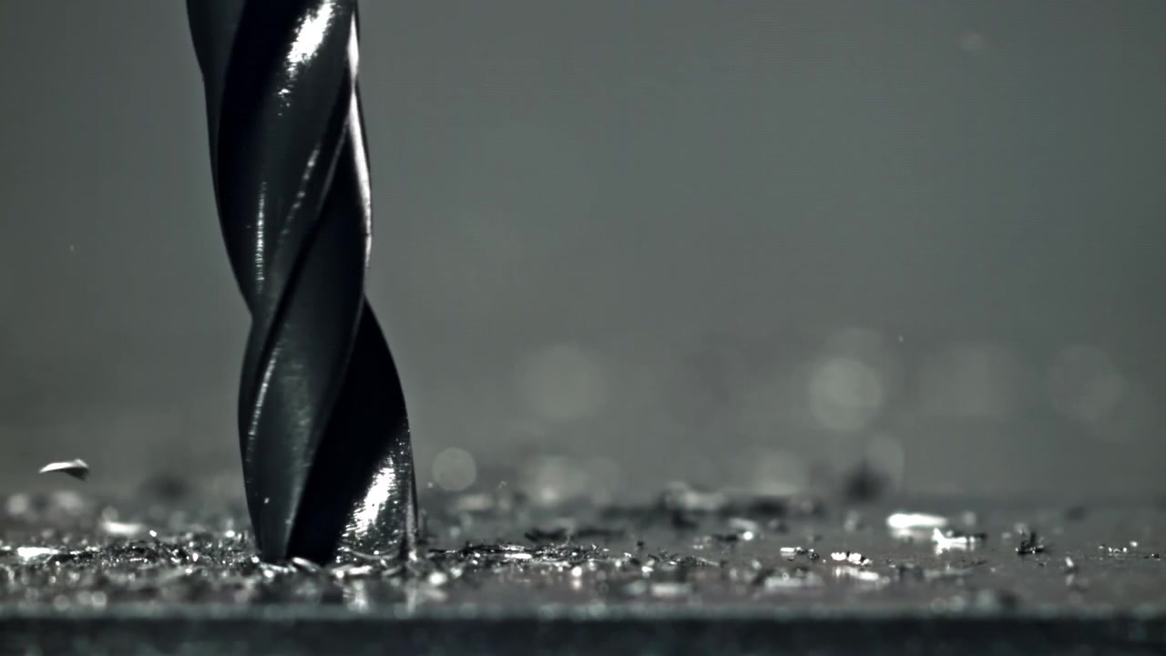 Close-up of an Industrial Drill Bit Machining Metal with Coolant