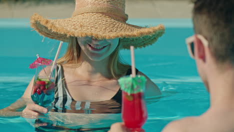 couple enjoying cocktails in a pool