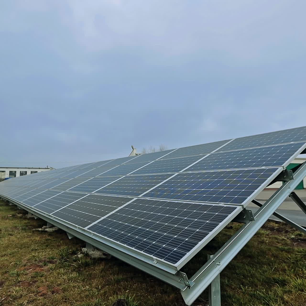 Long sunny battery on the field. Solar panel produces green clear energy from the sun. Arrangement of solar energy production plant.