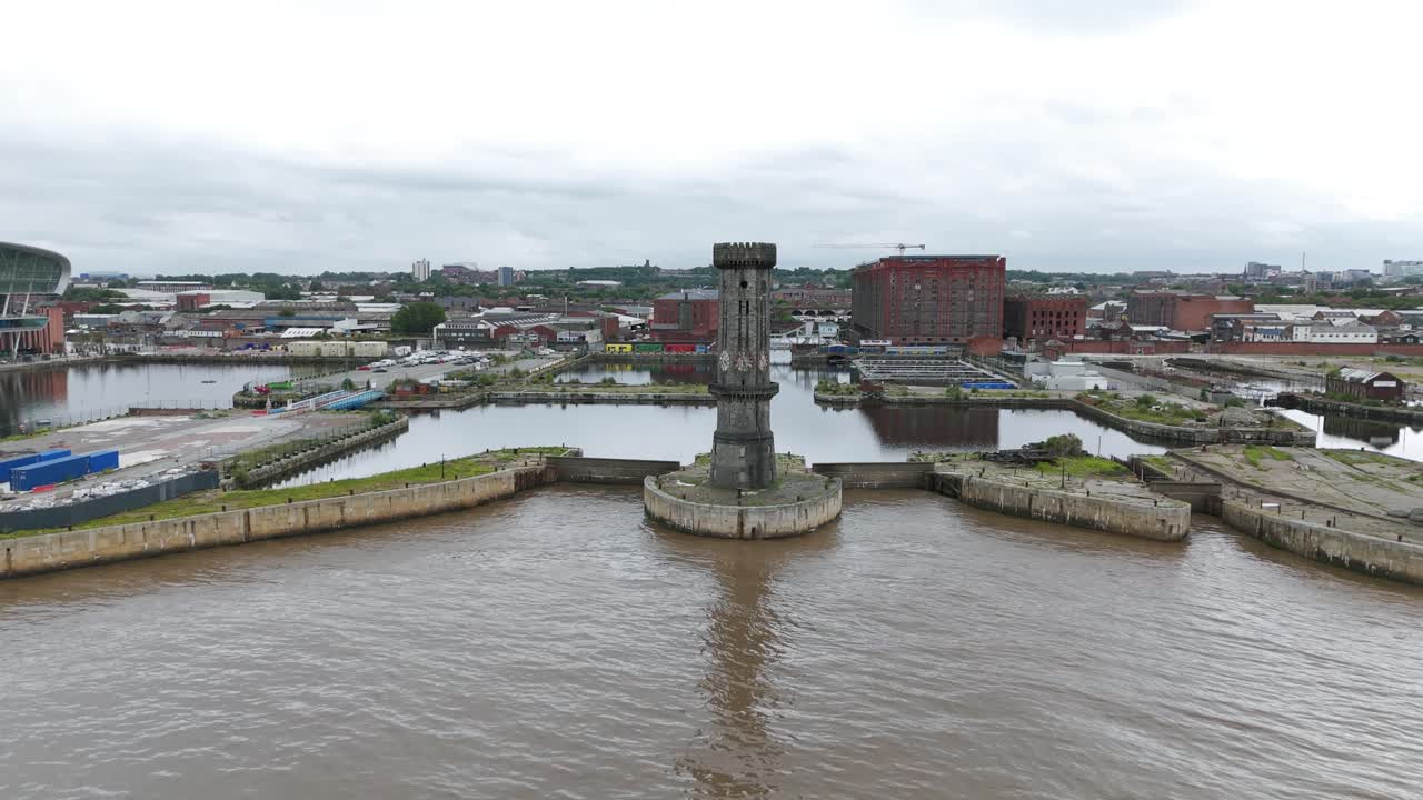 Historic Victoria Tower at Salisbury Dock entrance, industrial cityscape, Liverpool, UK. Aerial backward