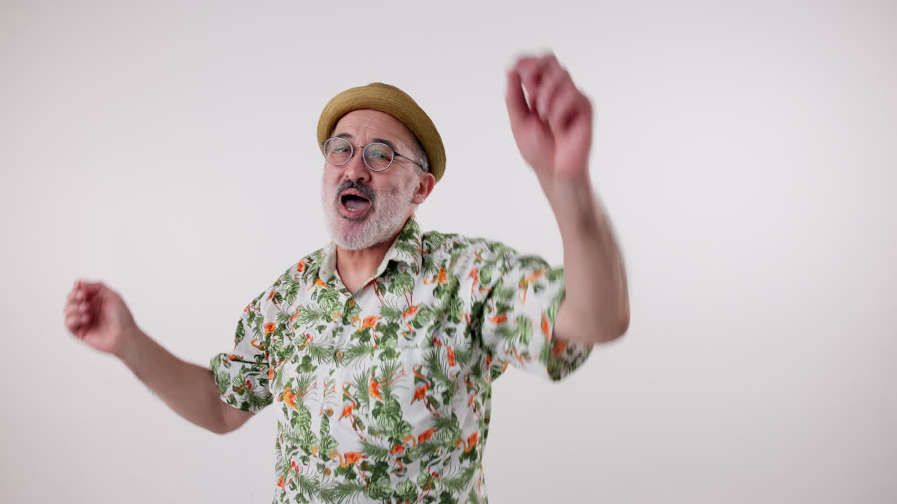 Man dancing in Hawaiian shirt and hat