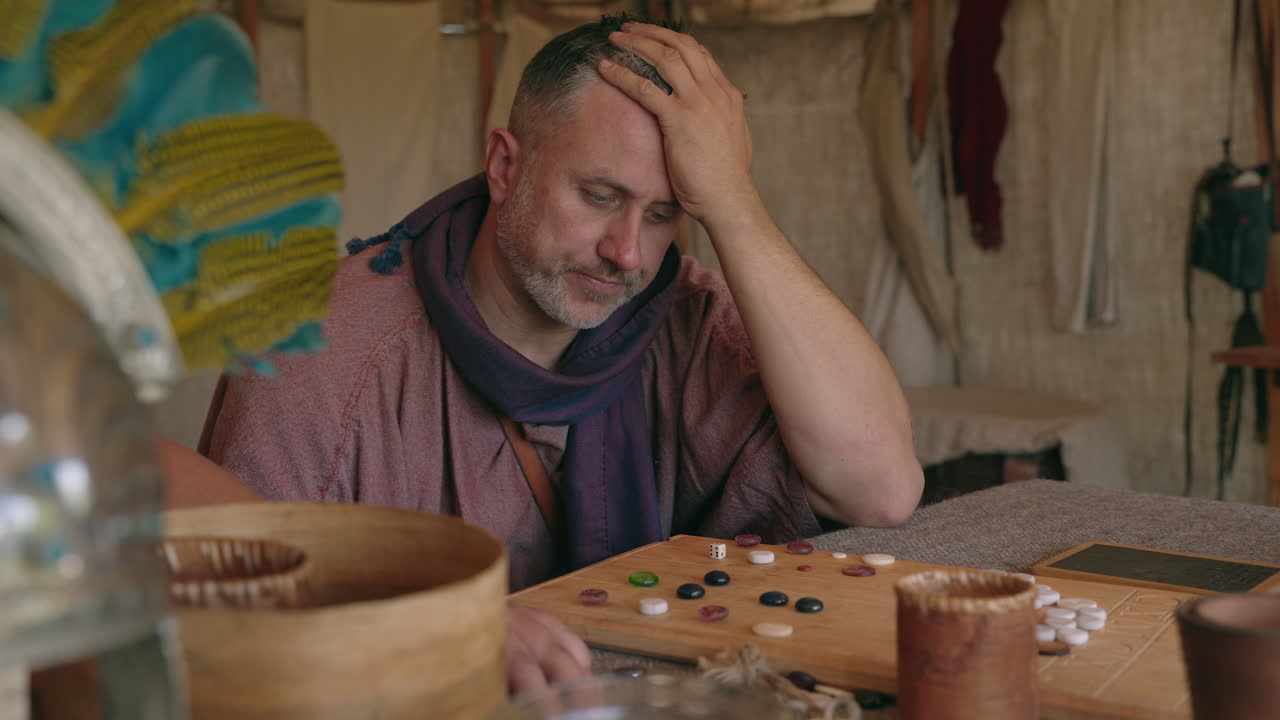 Man Playing a Historical Board Game