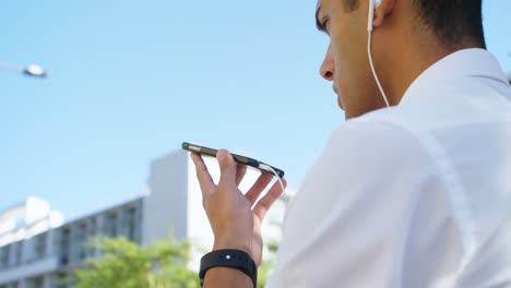 man talking on mobile phone while walking on street 4k
