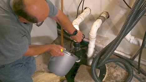 plumber working on a septic sewer in a house