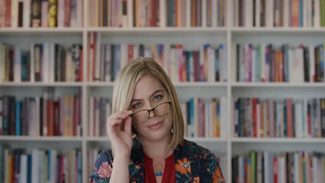 portrait successful young woman entrepreneur takes off glasses looking confident in library bookstore background slow motion