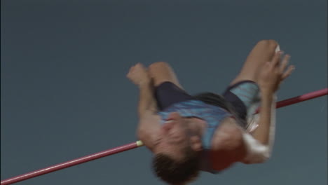 a man performs a high jump over a pole