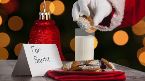 animation of santa claus picking cookies over orange spots of light